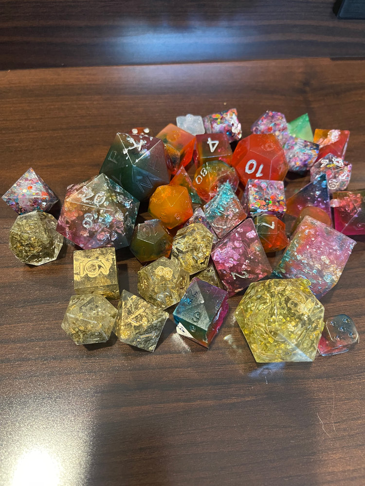 Set of colourful resin RPG dice with gold flake