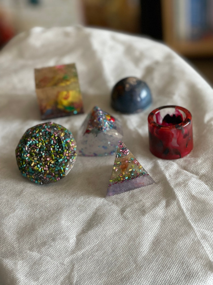 Assorted resin desk trinkets: cube, pyramid and sphere